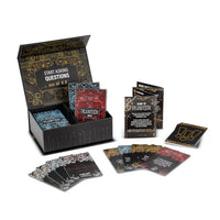 An open FLUSTER game box with the Laugh Pack, Spicy Pack, cards, and instruction booklet