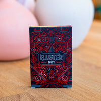 The FLUSTER Spicy Pack card game on a wooden surface